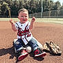 toddler, child, baseball, baseball_glove, baseball_field, sportswear, sneakers, jeans, jersey, outdoor, sunny, grass, dirt, playing, happy, sitting, young_child, sports_equipment, daytime, recreation