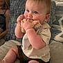 baby, child, infant, stuffed_toy, couch, cushion, person, sitting, indoors, home, soft_toy, blue_eyes, shorts, tshirt, cute, chubby, furniture, adult, woman, lamp