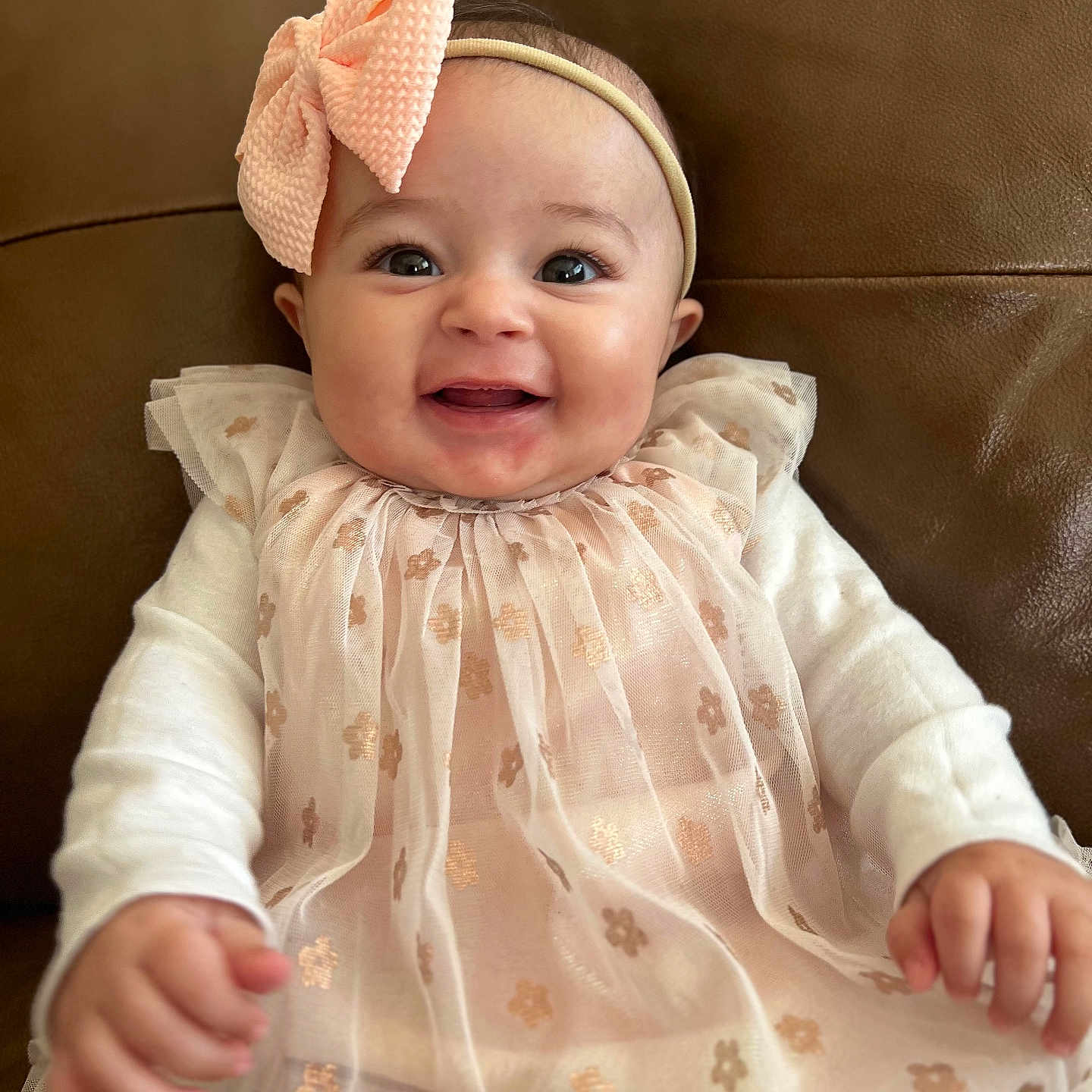 Gemma is registered to the contest to win money with this photo: accessories, baby, babylaughing, bodypart, clothing, cushion, dress, face, finger, hand, happy, hat, head, homedecor, newborn, person, photography, portrait, sitting, smile