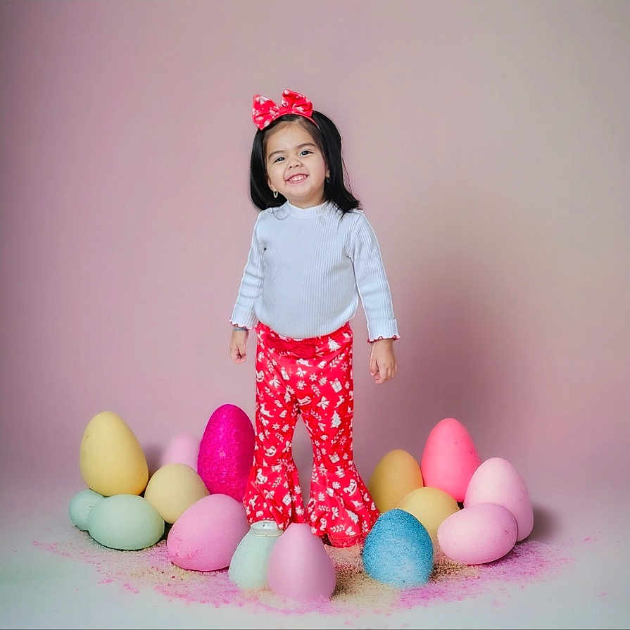 Bella is registered to the contest to win money with this photo: bodypart, child, clothing, egg, face, female, finger, food, girl, hand, happy, hat, head, pants, person, photography, portrait, purple, smile, sphere