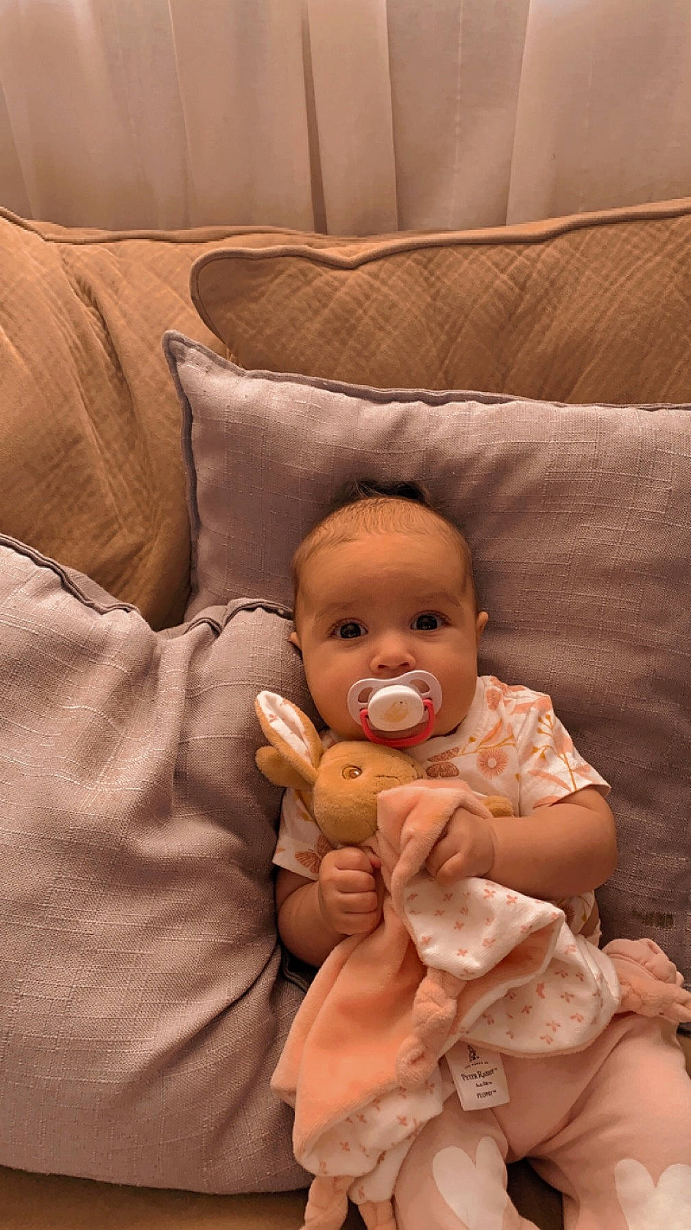 Leilani joined the competition — help win amazing prizes! abdomen, baby, baby_toddler_clothing, cheek, child, comfort, couch, gesture, home_accessories, lap, linens, peach, person, pillow, room, sitting, textile, throw_pillow, thumb, toddler