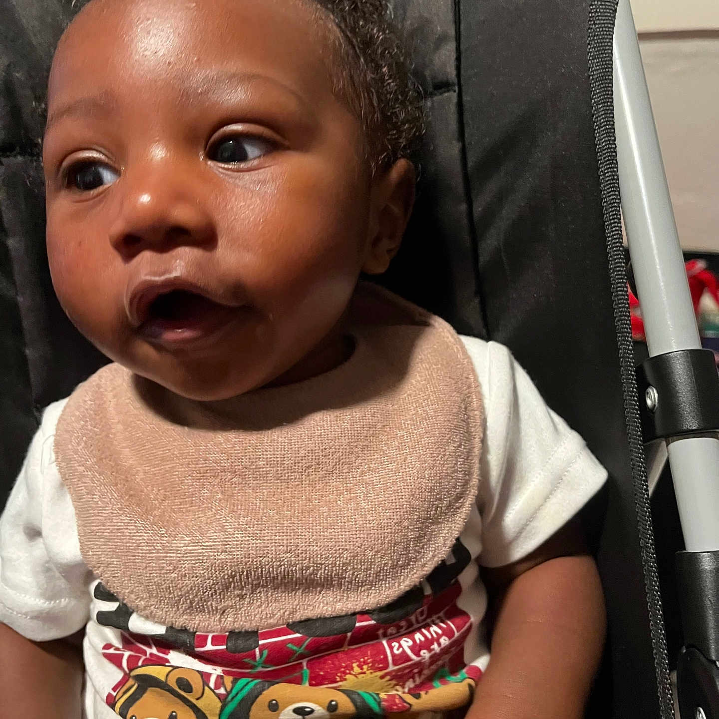 Elijah joined the competition — help win amazing prizes! baby, infant, child, toddler, bib, tshirt, cartoon, bear, stroller, seat, curious, expression, skin, hand, clothing, portrait, indoors, young, person, cute