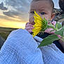 Valentina participe au concours pour gagner de l'argent avec cette photo : baby, flower, sunflower, blanket, outdoor, sunset, blue_eyes, person, nature, leaf, plant, closeup, portrait, infant, face, soft_texture, sky, clouds, greenery, holding