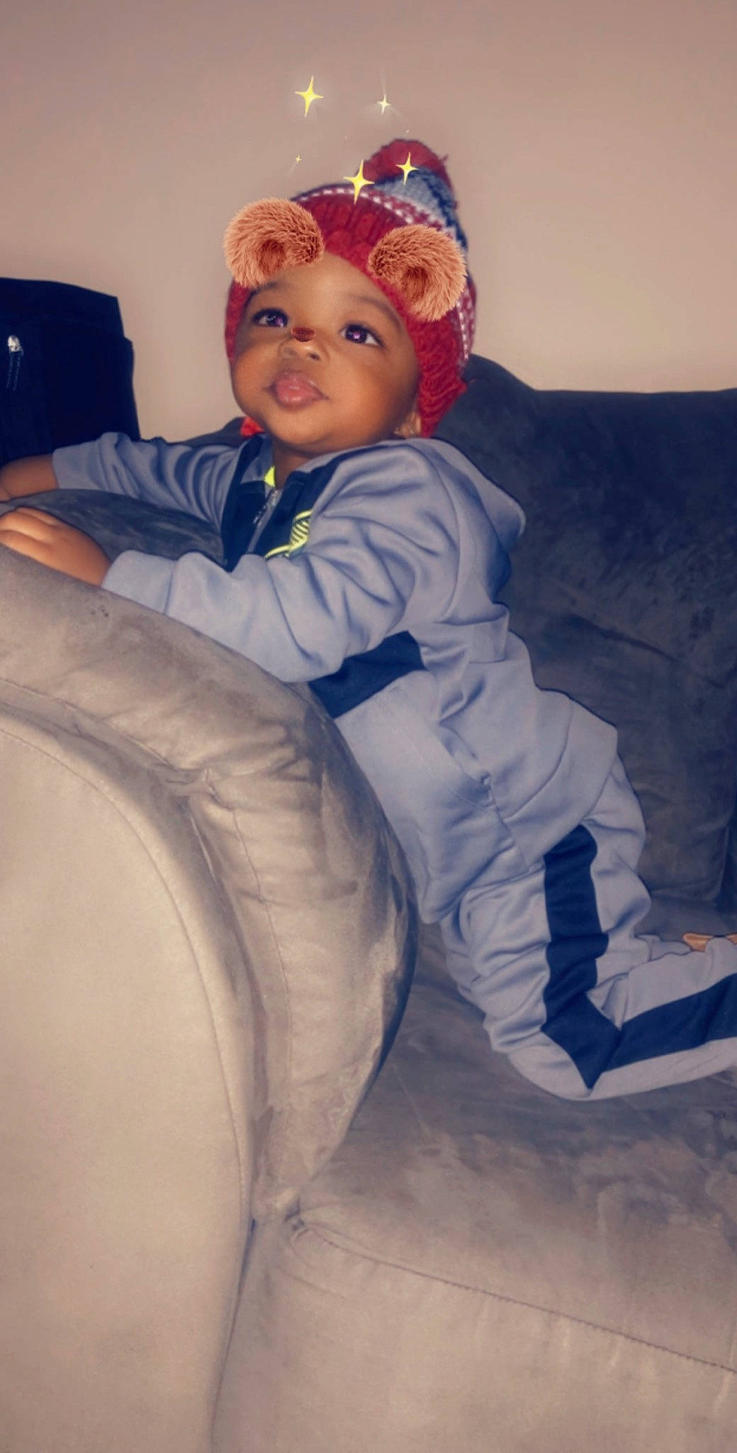 Isaiah is registered to the contest to win money with this photo: arm, blue, child, eye, headgear, leg, person, sitting, toddler