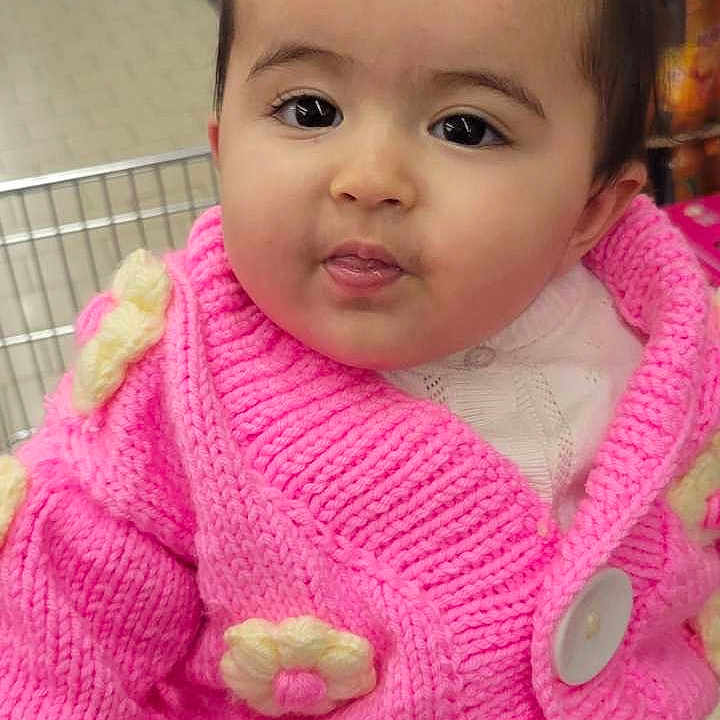 Bala participe au concours pour gagner de l'argent avec cette photo : aisle, baby, button, child, clothing, curious, cute, face, flowers, grocery_store, indoor, infant, knitwear, person, pigtails, pink_sweater, portrait, shopping_cart, supermarket, young_child