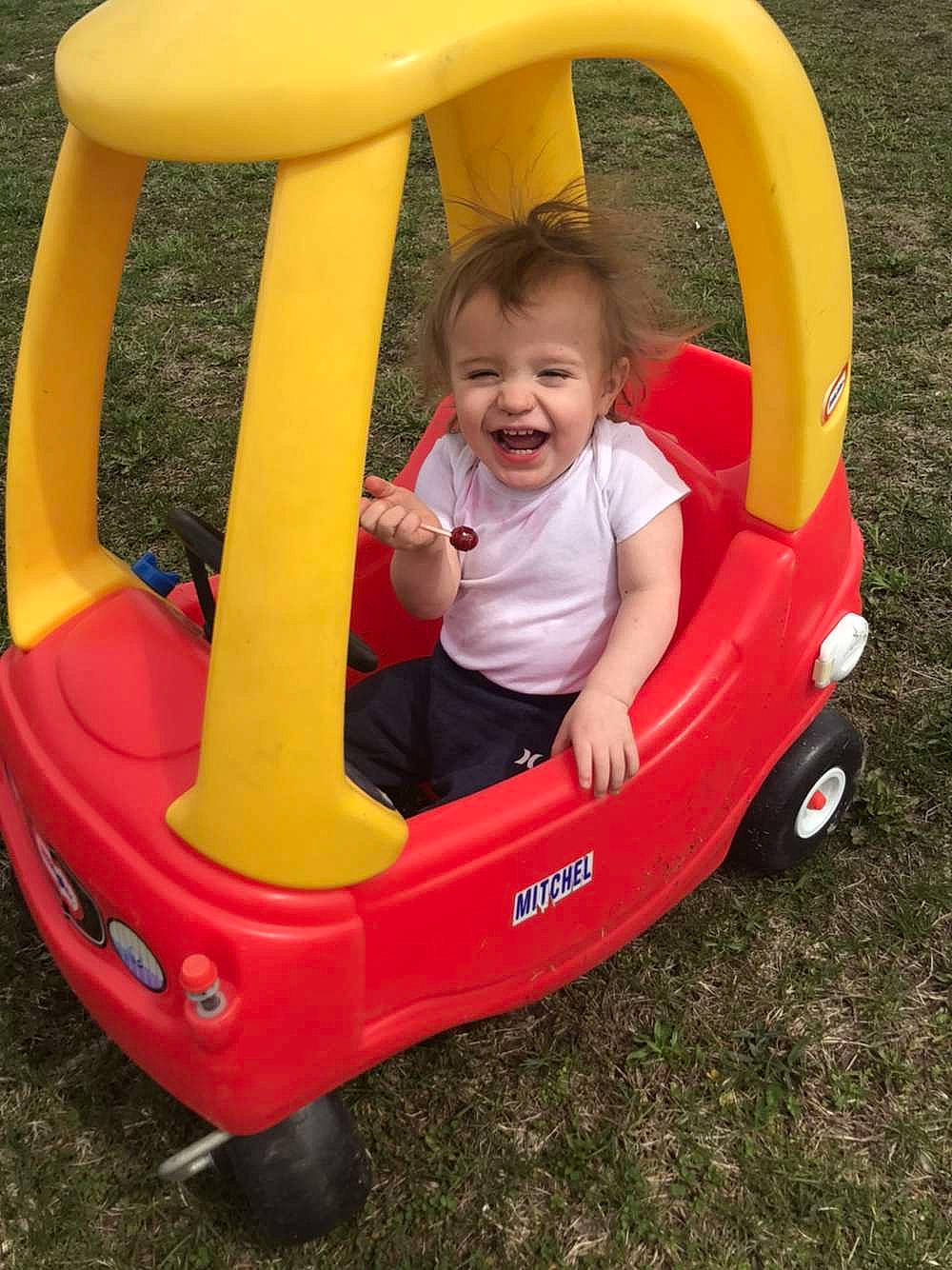 Jaxton is registered to the contest to win money with this photo: automotive_exterior, baby, baby_products, baby_toddler_clothing, bumper, child, fun, grass, happy, head, leisure, motor_vehicle, person, photograph, product, recreation, smile, tire, toddler, vehicle