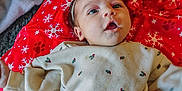 Sadie joined the competition — help win amazing prizes! baby, bow, carpet, child, christmas_wrapping, closeup, cute, festive, gifts, headband, holiday, infant, lying_down, onesie, pajamas, portrait, presents, red_blanket, snowflake_pattern, wide_eyed