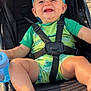 baby, barefoot, beach, blue_sippy_cup, cap, casual, child, cute, frog_pattern, green_clothing, happy, headwear, infant, outdoor, person, seatbelt, smiling, stroller, summer, sunny