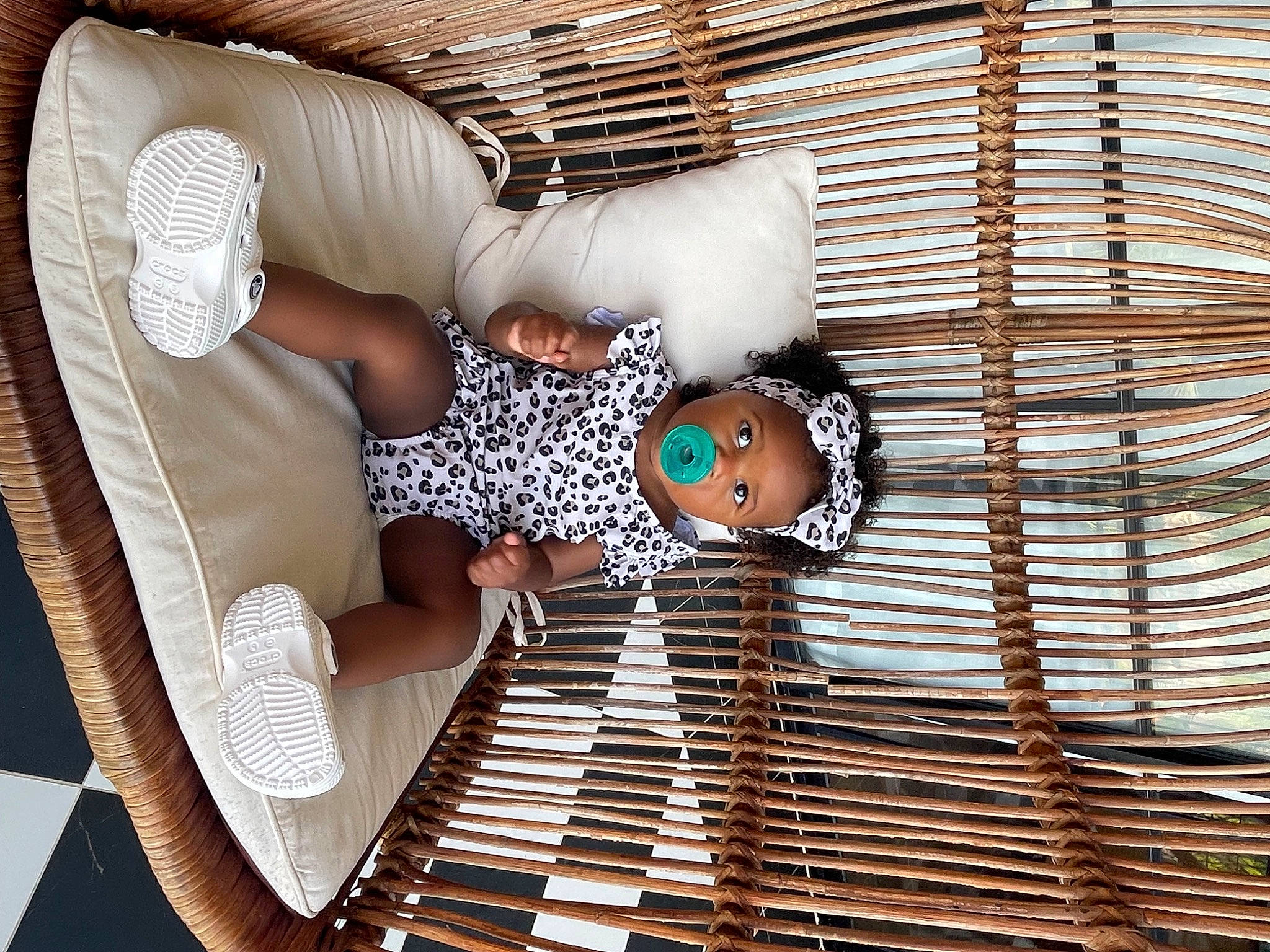 Haven is registered to the contest to win money with this photo: chair, child, comfort, couch, daylighting, hat, human_leg, leisure, metal, outdoor_furniture, pattern, person, room, sitting, textile, thigh, toddler, wood