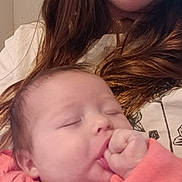 Grace joined the competition — help win amazing prizes! baby, sleeping, thumb_sucking, adult, woman, face, hair, long_hair, pink_clothing, white_shirt, closeup, portrait, indoor, person, skin, hand, comfort, love, family, tender_moment