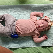 Grace joined the competition — help win amazing prizes! baby, sleeping, infant, headband, pink_clothing, grey_pants, blanket, quilted, peaceful, nap, soft, indoor, child, person, cute, resting, mobile_phone, fabric, texture, cozy