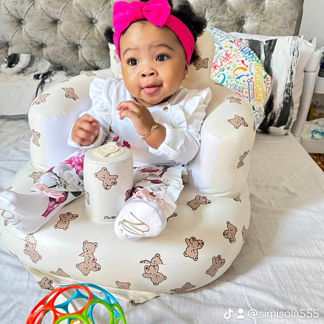 Tiarah is registered to the contest to win money with this photo: baby, beanbag, bodypart, chair, clothing, couch, cushion, face, finger, furniture, hand, hat, head, homedecor, people, person, photography, pillow, portrait, sitting