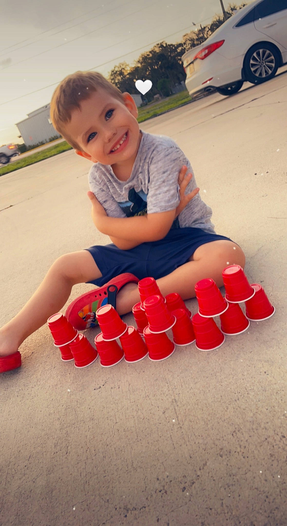 Angel is registered to the contest to win money with this photo: car, carmine, child, electric_blue, event, flooring, fun, happy, human_leg, joy, leisure, person, recreation, shorts, sitting, smile, t_shirt, tire, toddler, vehicle