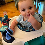 Colton joined the competition — help win amazing prizes! baby, child, infant, smiling, portrait, indoors, activity_walker, baby_toy, finger, hand, blue_clothing, seated, wooden_floor, furniture, home, playtime, happy, face, photograph, family