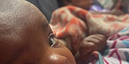 Zanaija Tate joined the competition — help win amazing prizes! baby, bottle, feeding, infant, blanket, closeup, child, indoors, couch, face, hand, portrait, young_child, sleeping, soft_lighting, furniture, bottle_feeding, two_children, blurred_background, cozy