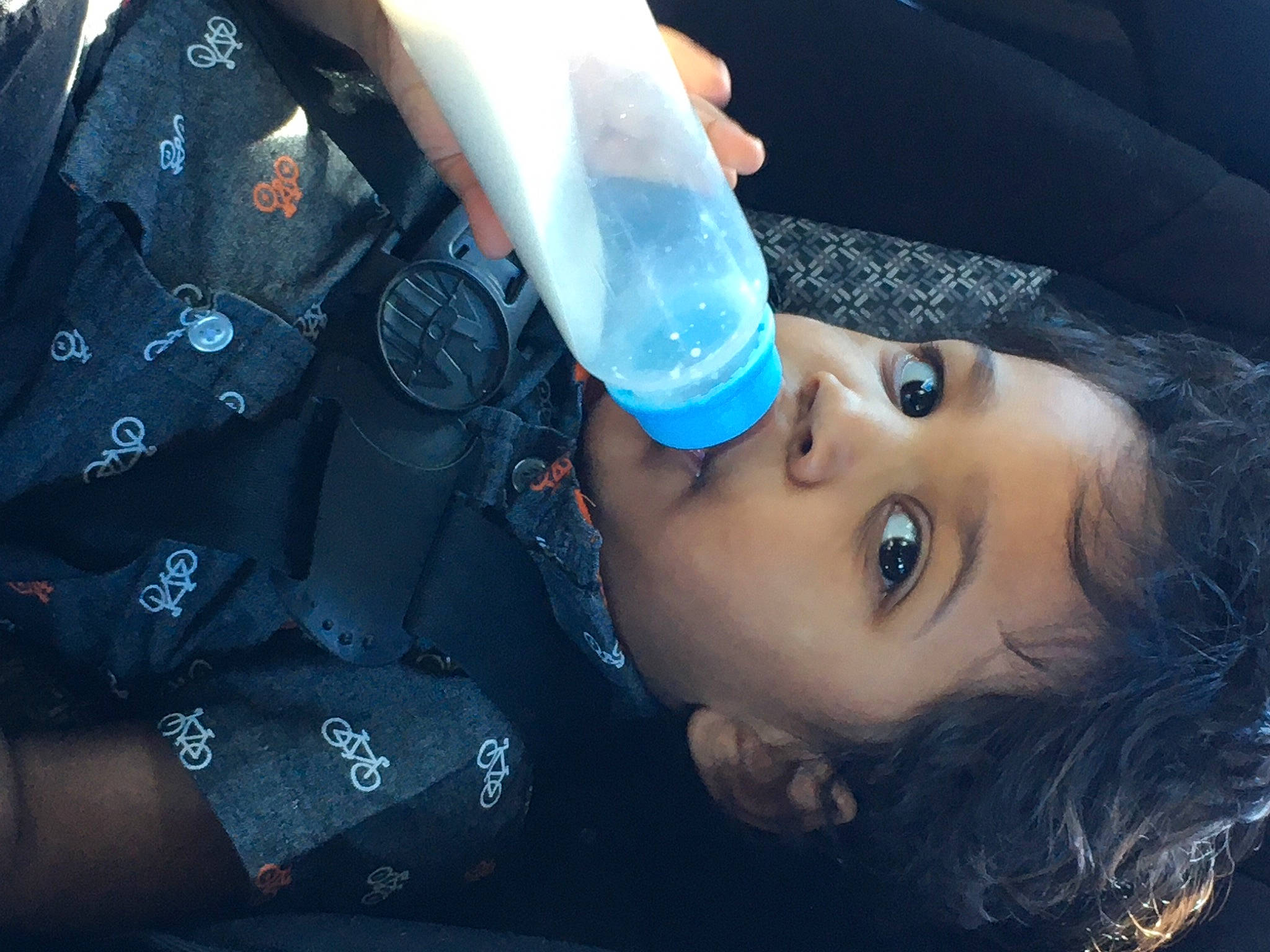 Noah is registered to the contest to win money with this photo: automotive_lighting, azure, black_hair, drinkware, electric_blue, eyebrow, eyelash, flash_photography, fluid, gesture, helmet, lip, liquid, nail, person, plant, plastic_bottle, skin, tree, water