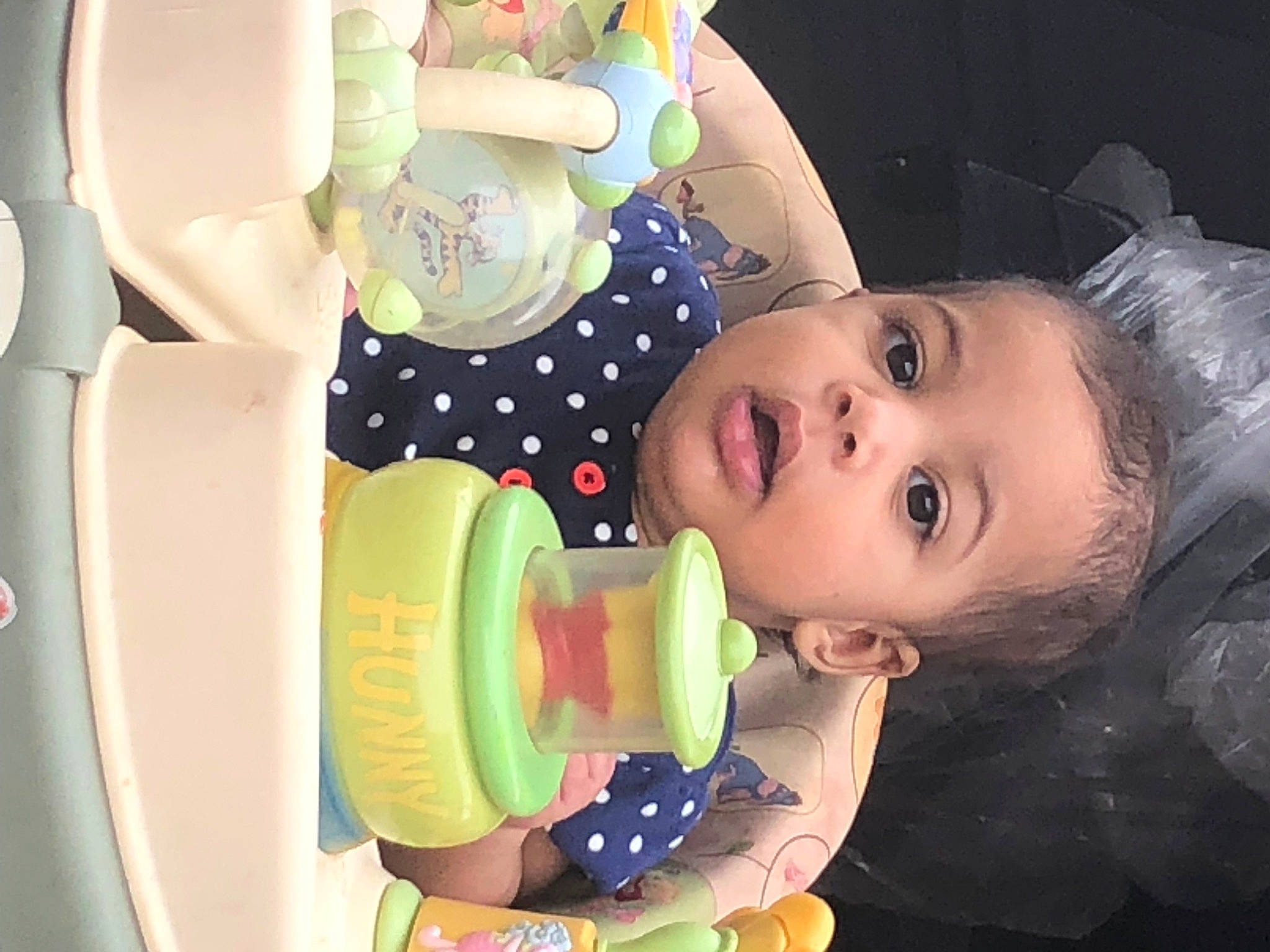 Maria is registered to the contest to win money with this photo: baby, baby_playing_with_toys, baby_products, baby_toddler_clothing, baby_toys, cheek, child, drinkware, eye, eyelash, fun, happy, head, mouth, nose, party_supply, person, product, skin, sweetness