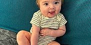 Killian joined the competition — help win amazing prizes! baby, child, infant, smiling, sitting, onesie, foot, hand, blanket, couch, blue_background, happy, cute, playful, indoors, skin, face, eyes, hair, young