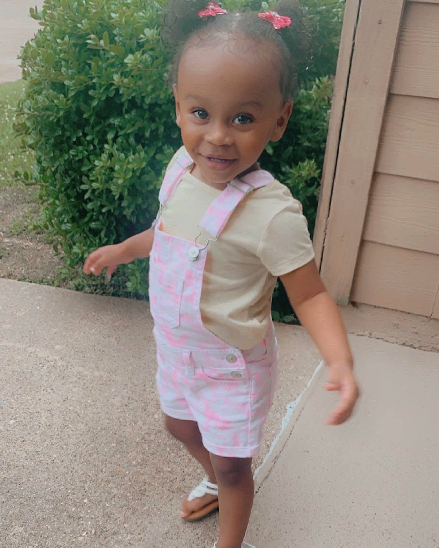 Kylei is registered to the contest to win money with this photo: baby, baby_toddler_clothing, child, face, foot, grass, hair, hairstyle, happy, head, human_body, joy, magenta, pattern, person, pink, plant, skin, sleeve, standing