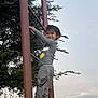 child, climbing, ladder, outdoor, tree, sky, cloud, streetlight, smile, nike, clothing, sneakers, playground, person, evening, activity, nature, metal, casual, fun