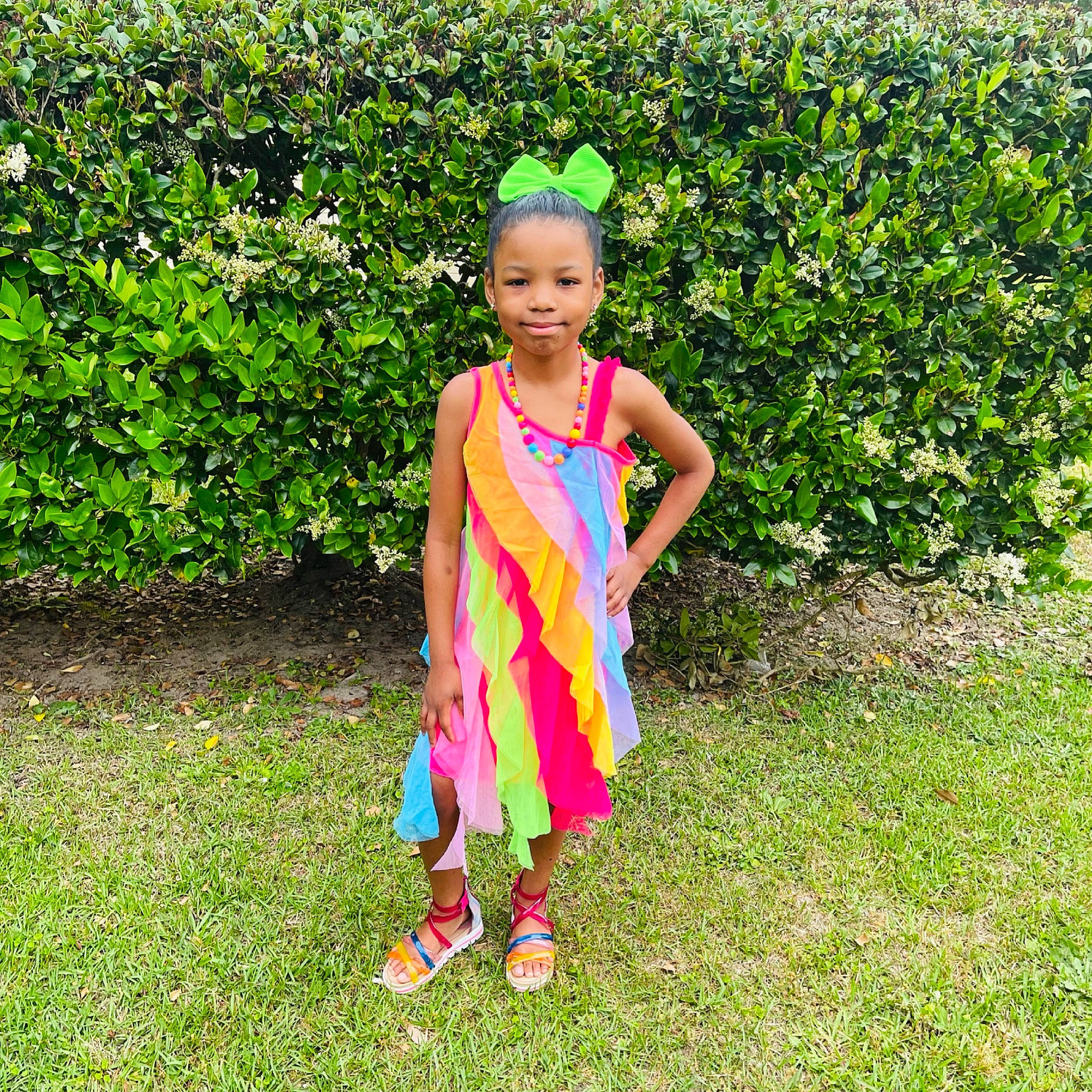 Aryanna is registered to the contest to win money with this photo: baby_toddler_clothing, child, day_dress, electric_blue, fashion_accessory, fun, garden, grass, grassland, happy, joy, magenta, meadow, one_piece_garment, pattern, people_in_nature, person, plant, play, sandal