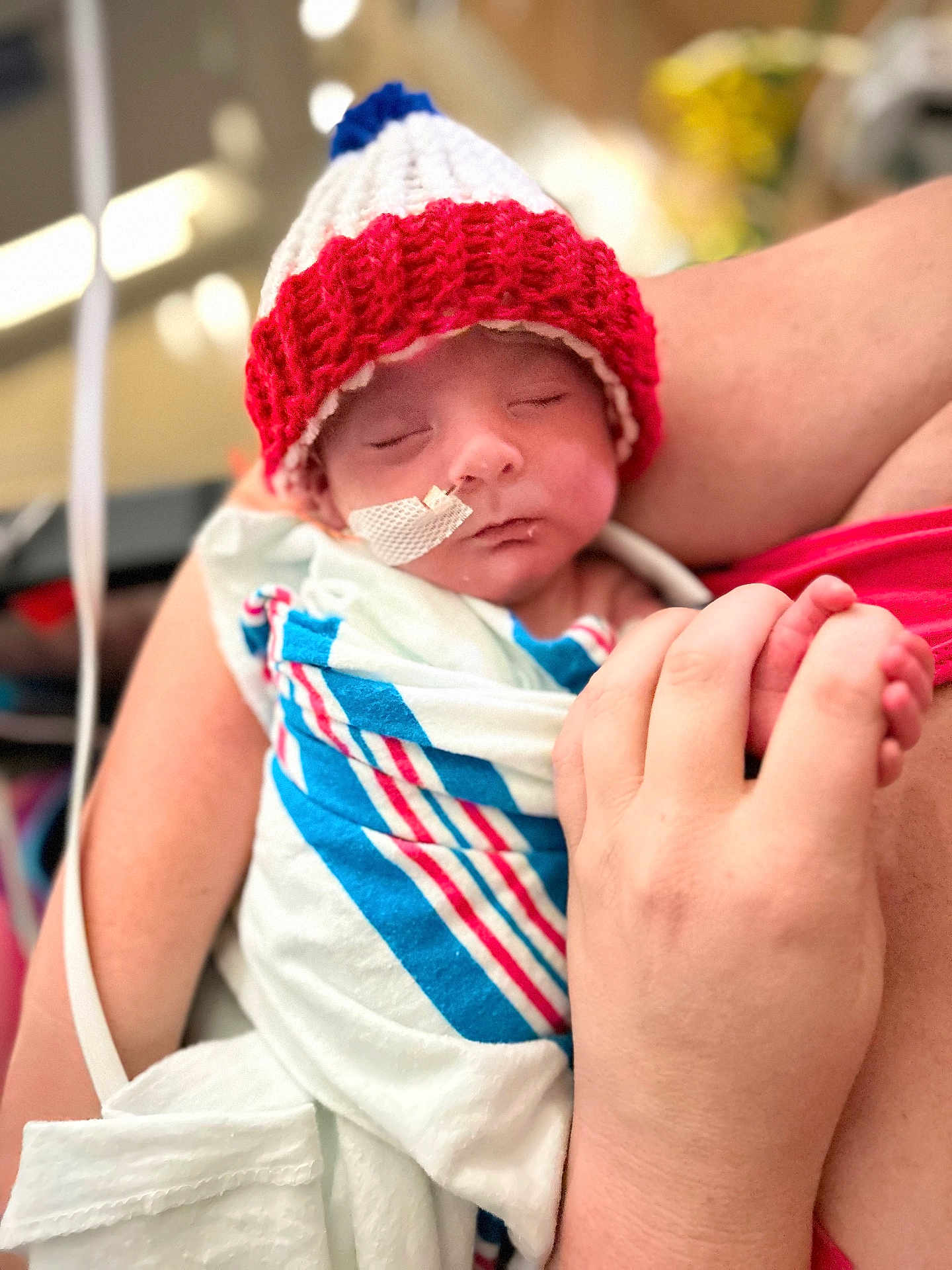 Jessy joined the competition — help win amazing prizes! newborn, baby, infant, hospital, blanket, knitted_hat, medical_tape, tube, sleeping, person, arm, hand, closeup, care, child, swaddled, rest, skin, red, blue
