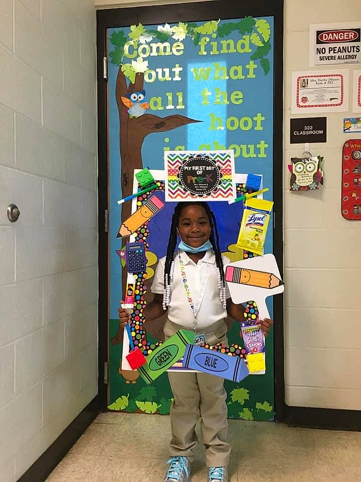 Nevaeh is registered to the contest to win money with this photo: advertising, art, building, child, costume, creative_arts, door, event, green, joy, machine, person, room, smile, toddler, visual_arts, world