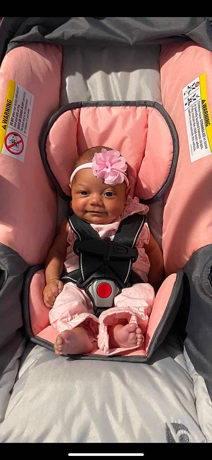 Isabella is registered to the contest to win money with this photo: baby, baby_products, baby_safety, baby_toddler_clothing, car_seat, cheek, child, comfort, event, fun, happy, magenta, person, pink, room, service, sitting, smile, thumb, toddler