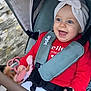 Athèna participe au concours pour gagner de l'argent avec cette photo : baby, child, stroller, red_clothing, headwrap, smiling, toy, seatbelt, outdoor, happy, cute, infant, toddler, playful, comfort, casual, walking, love, heart_pattern, portrait