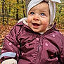 baby, child, autumn, forest, leaves, outdoor, smile, happy, jacket, headwrap, blue_eyes, cute, seasonal, nature, fall, warm_clothing, portrait, person, sitting, playful