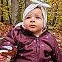 Athèna a rejoint le concours — aidez-le/la à gagner de superbes lots ! toddler, child, autumn, forest, leaf, jacket, headband, bow, outdoor, nature, fall_foliage, cute, portrait, young_child, seasonal, clothing, baby, person, expression, warm