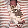 newborn, baby, sleeping, pacifier, teddy_bear, plush_toy, blanket, striped_blanket, infant, onesie, portrait, lying_down, indoors, peaceful, closed_eyes, barefoot, nursery, cuddly, soft_toy, cozy