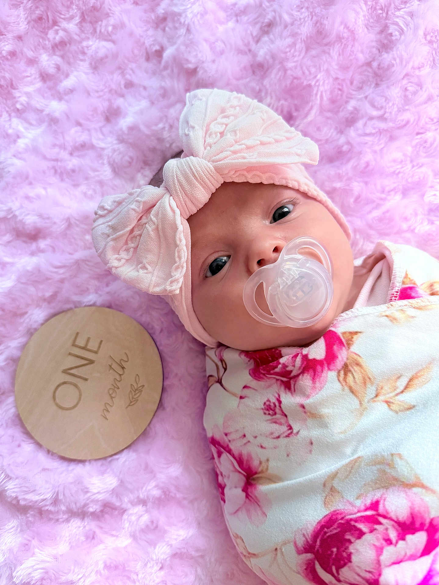 Thorn Lilith joined the competition — help win amazing prizes! baby, infant, pacifier, headband, bow, blanket, floral_pattern, pink_background, wooden_plaque, month_marker, portrait, cute, soft_texture, newborn, child, wrapped, lying_down, closeup, face, indoors