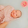 baby, newborn, pink_cloth, milky_water, flower, pink_flower, white_flower, floating, peaceful, serene, portrait, skin, face, infant, closeup, water, soft_light, delicate, baby_wrapped, calm