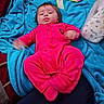 Lilith joined the competition — help win amazing prizes! baby, infant, child, portrait, lying_down, pink_outfit, blanket, blue_blanket, pillow, indoor, cozy, face, dark_hair, open_eyes, looking_at_camera, baby_clothing, bright_colors, candid_photo, seated_surface, home