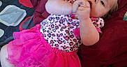 Lilith joined the competition — help win amazing prizes! baby, child, infant, smiling, lying_down, portrait, pink_tutu, leopard_print, dress, blanket, bed, car_seat, indoor, cozy, playful, finger_nibbling, blue_eyes, clothing, family, casual_photo
