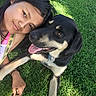 girl, person, dog, pet, outdoor, grass, portrait, selfie, cuddling, smiling, happy, animal, black_and_white, large_dog, tongue_out, lying_down, summer, sunlight, lanyard, friendship