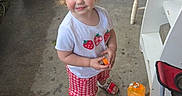 Wrenly joined the competition — help win amazing prizes! child, toddler, girl, smiling, outdoor, patio, brick_wall, cooler, chair, ladder, suitcase, drink_container, strawberry_shirt, checkered_shorts, sandals, blonde_hair, pigtails, portrait, standing, backyard