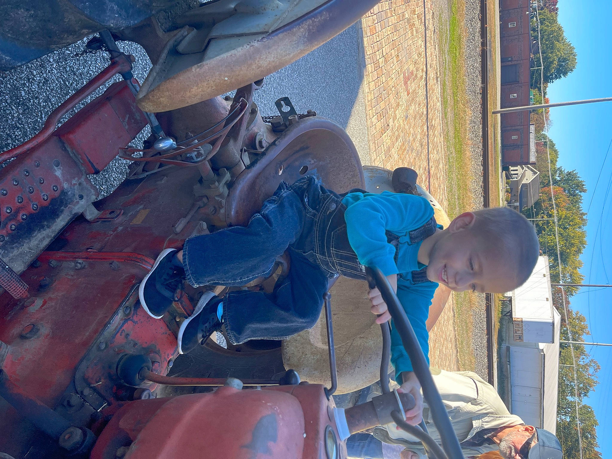 Liam is registered to the contest to win money with this photo: auto_part, automotive_exterior, automotive_tire, automotive_wheel_system, blue_collar_worker, bumper, elbow, electric_blue, engineering, gas, hat, headwear, hood, joy, machine, mechanic, motor_vehicle, person, plant, sky