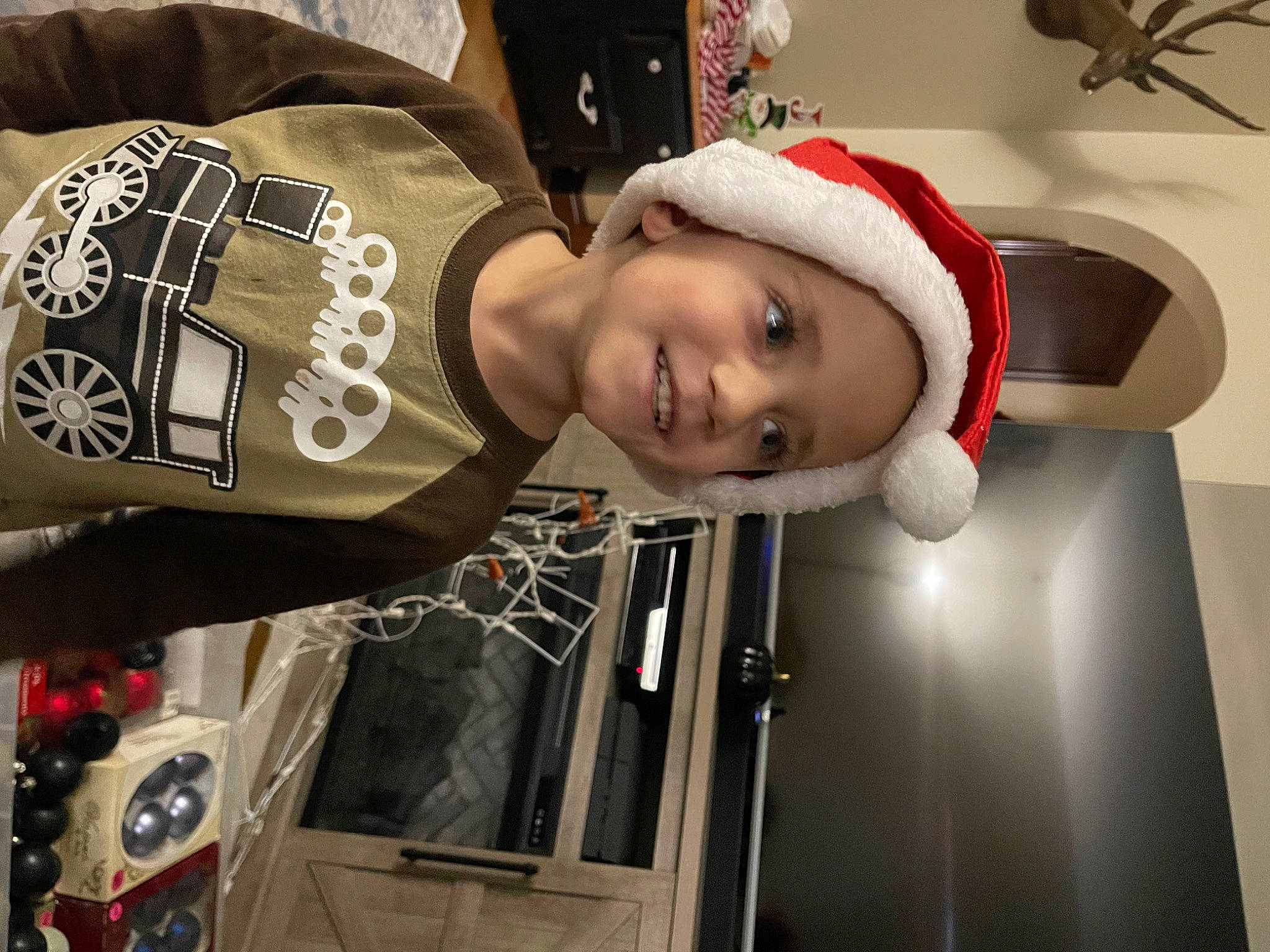 Liam is registered to the contest to win money with this photo: automotive_design, cap, carmine, costume, costume_hat, event, fashion_accessory, fun, happy, hat, headgear, headwear, holiday, jersey, joy, person, personal_protective_equipment, smile, sportswear, tire