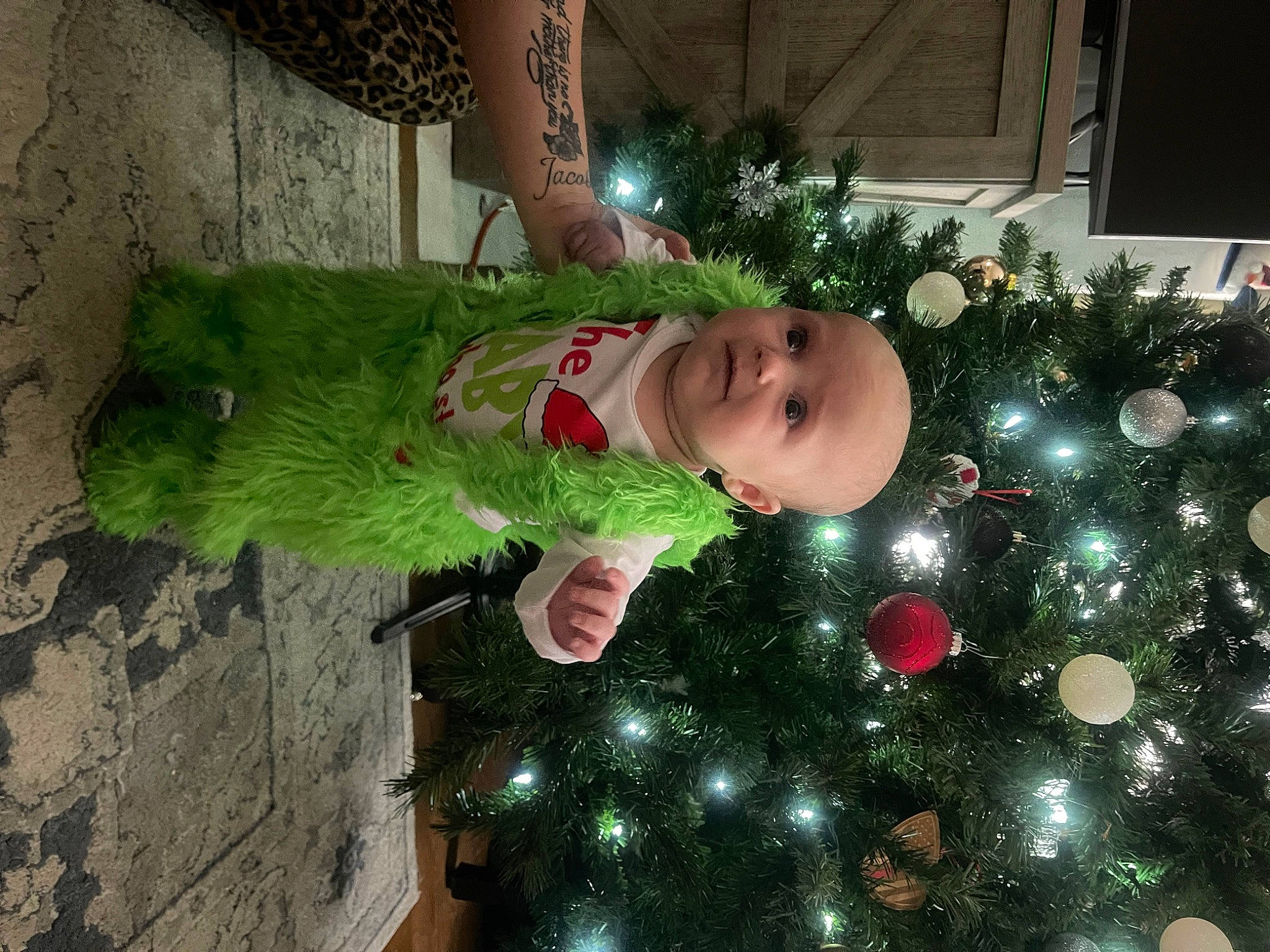 Walker joined the competition — help win amazing prizes! baby, child, christmas, christmas_decoration, christmas_eve, christmas_ornament, christmas_tree, conifer, event, evergreen, happy, holiday, holiday_ornament, lap, natural_material, ornament, person, plant, smile, toddler