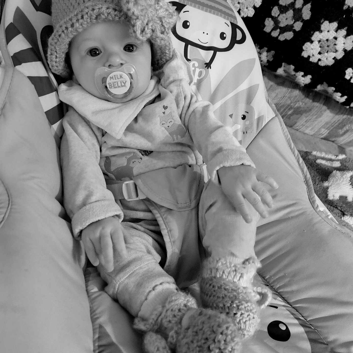 Arabella is registered to the contest to win money with this photo: baby, beanie, bodypart, bonnet, cap, clothing, coat, couch, cushion, face, finger, furniture, glove, hand, hat, head, homedecor, person, photography, portrait
