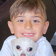 Skye is registered to the contest to win money with this photo: child, dog, white_dog, pet, boy, smiling, hugging, indoor, closeup, cute, collar, short_hair, happy, face, portrait, friendship, cozy, animal, pet_collar, young