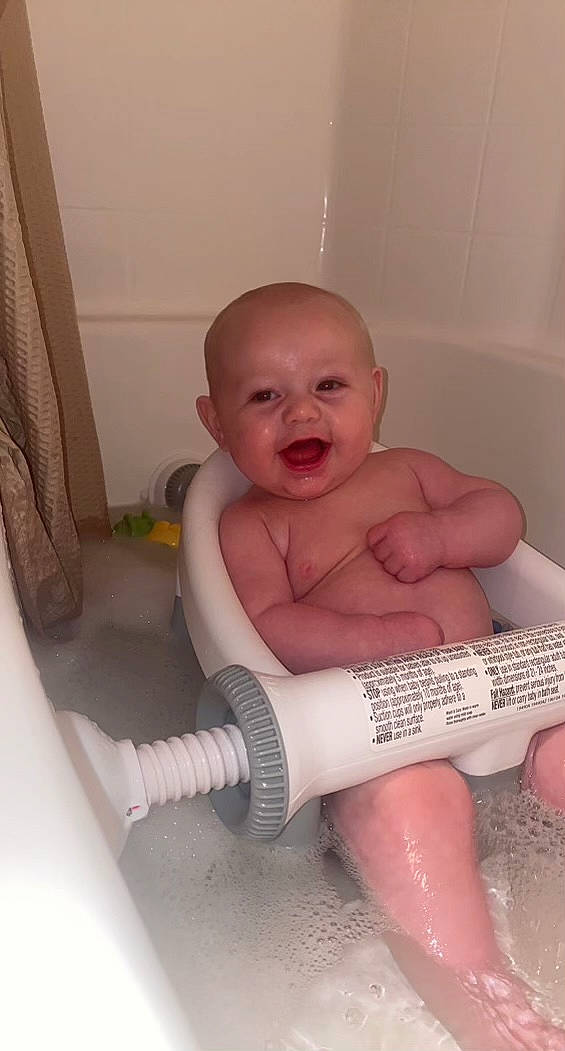 Axton is registered to the contest to win money with this photo: baby, bathing, bathroom, bathtub, chest, child, eye, eyelash, human_body, human_leg, iris, jaw, mouth, person, plumbing, plumbing_fixture, skin, smile, thigh, thumb