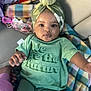 Xialyn is registered to the contest to win money with this photo: baby, child, green_turban, green_shirt, plaid_blanket, indoor, portrait, cute, face, hand, clothing, infant, lying_down, looking_at_camera, soft_lighting, casual, expression, cozy, support, person