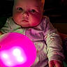 baby, child, face, pajamas, glowing_orb, light, colorful_light, hand, indoor, portrait, cute, infant, expressionless, holding, night, soft_light, skin, young_child, person, cozy