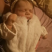 Miley joined the competition — help win amazing prizes! baby, bed, blanket, bow, child, clothing, cozy, cute, fabric, face, fist, hand, headband, indoors, infant, peaceful, portrait, sleeping, soft_lighting, white_jacket