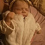 baby, bed, blanket, bow, child, clothing, cozy, cute, fabric, face, fist, hand, headband, indoors, infant, peaceful, portrait, sleeping, soft_lighting, white_jacket