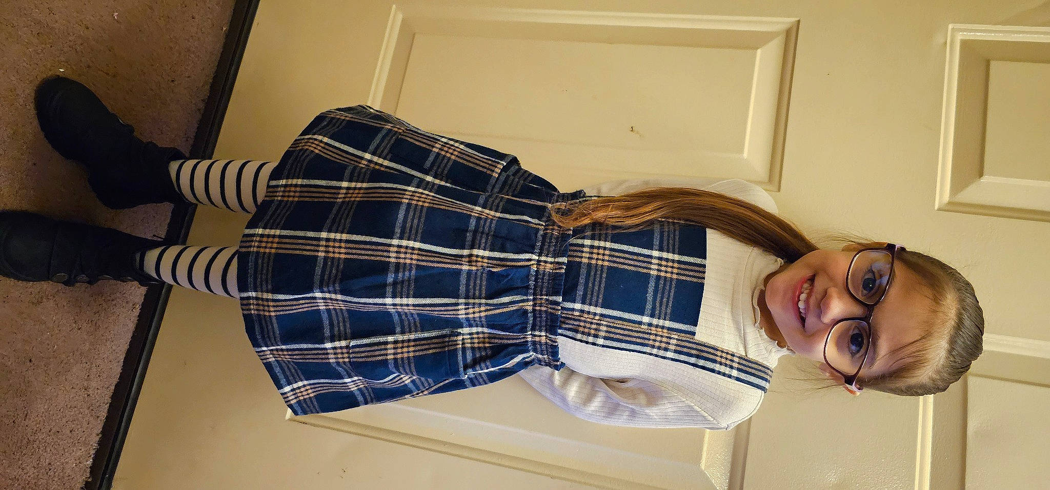 Alyssa is registered to the contest to win money with this photo: comfort, couch, dress_shirt, elbow, eyewear, flooring, human_leg, joy, leg, linens, pattern, person, plaid, room, sitting, sleeve, smile, sock, tartan, thigh