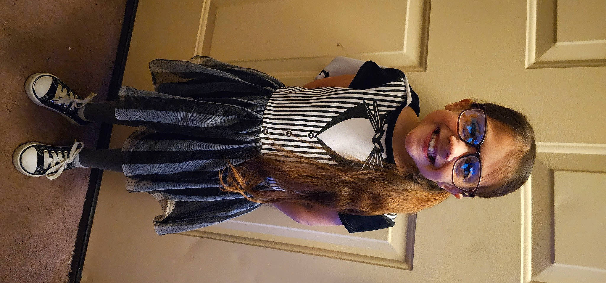 Alyssa is registered to the contest to win money with this photo: art, comfort, dress, eyewear, fashion_design, happy, hat, headgear, joy, person, personal_protective_equipment, room, smile, thigh, waist, window, wood